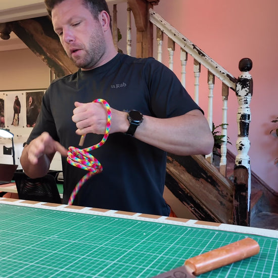 Ben from Re:Made hand-tying a rainbow Tendon® climbing rope handsfree dog lead in the UK workshop